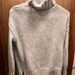 oversized turtleneck sweater in a light gray color.